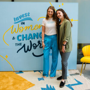 Women's Venture Summit attendees standing in front of mural